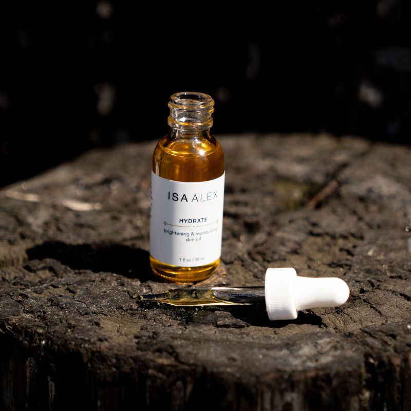 ISA ALEX skincare serum bottle with dropper on a dark surface