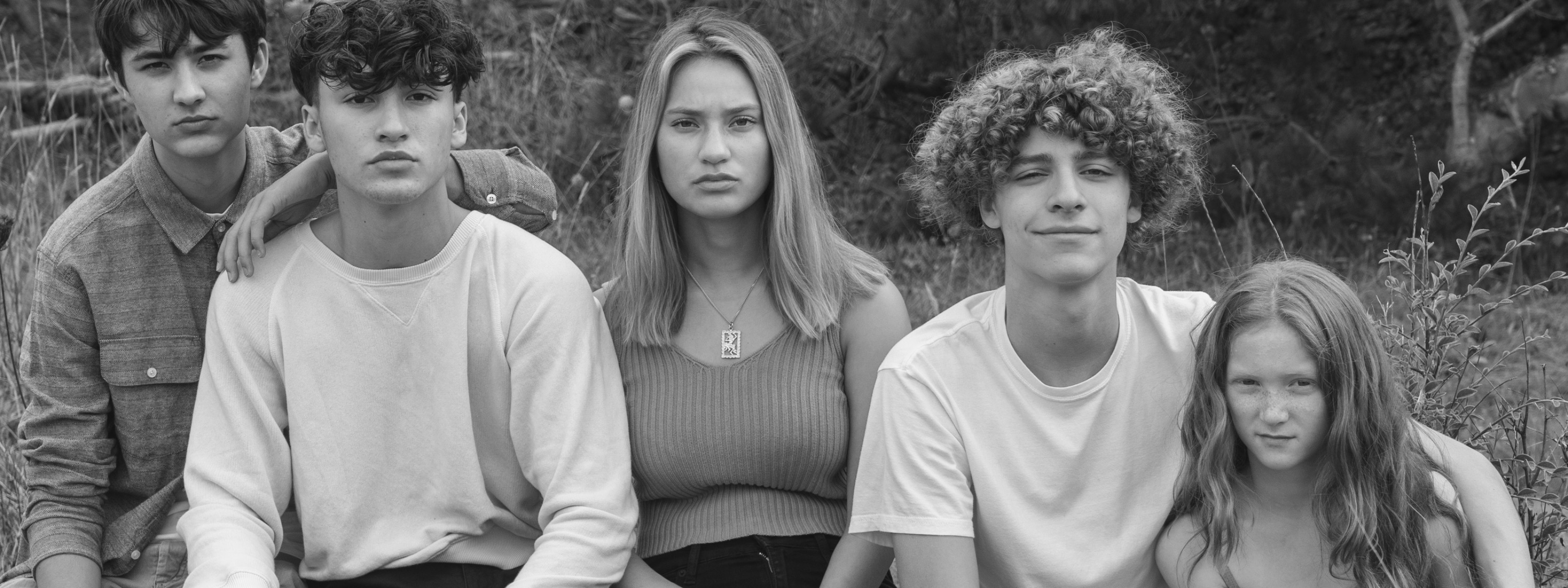 Black and white photo of teens and preteens outside showcasing the results of the Clear Skin Confidence Online Course for teens. Designed by expert esthetician, Gunilla Founder of Isa Alex skincare.