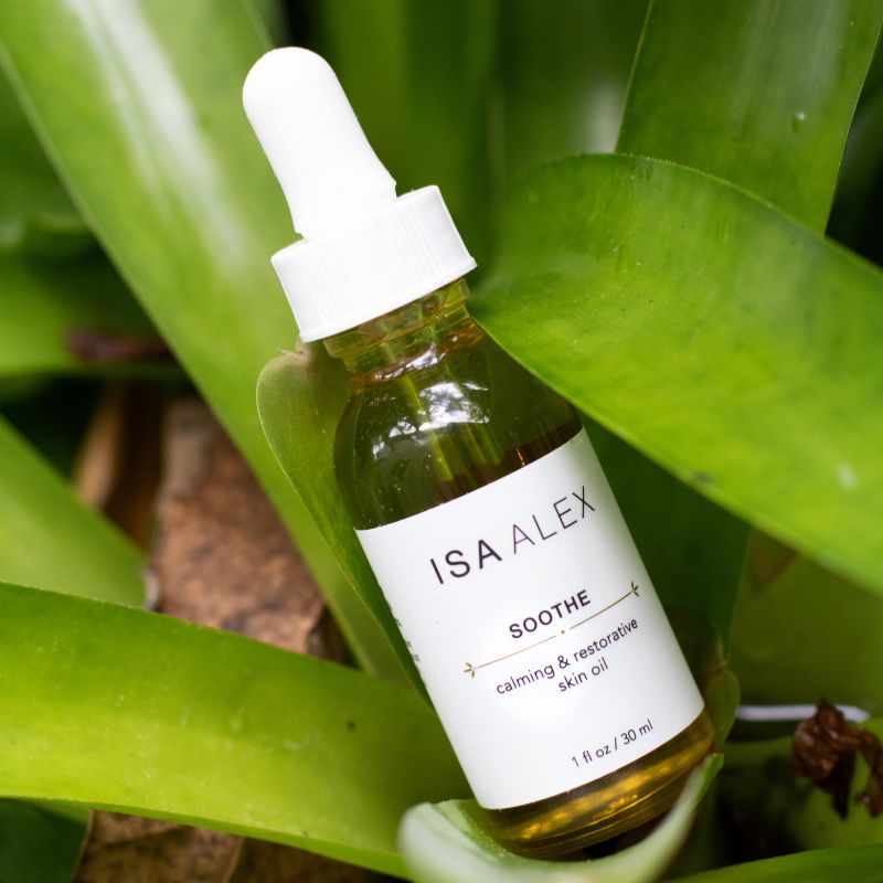ISA ALEX skincare oil bottle with dropper on green leaves