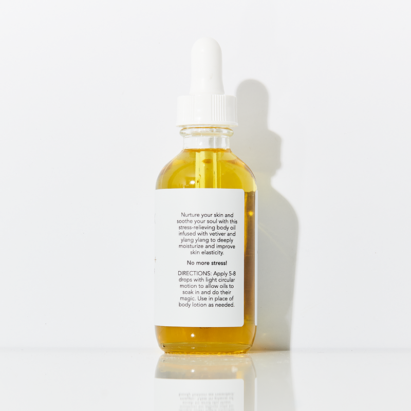 Bottle of skincare oil with dropper on a white background