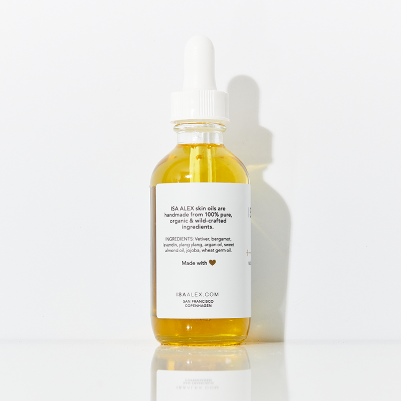 Bottle of ISA ALEX skincare oil with a white label on a light background