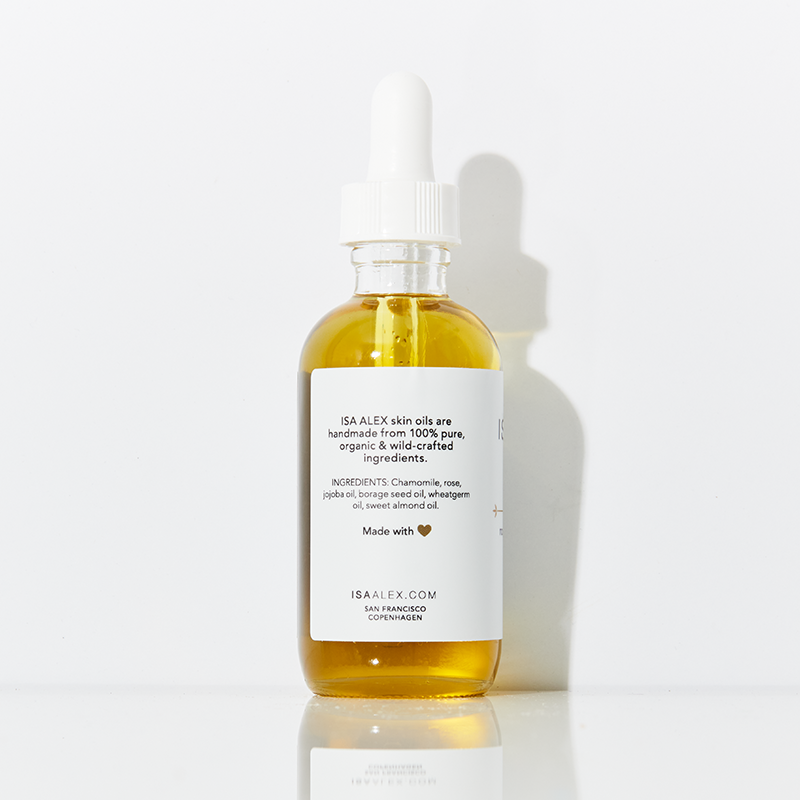 Bottle of IS ALEX skincare oil with a dropper on a white background